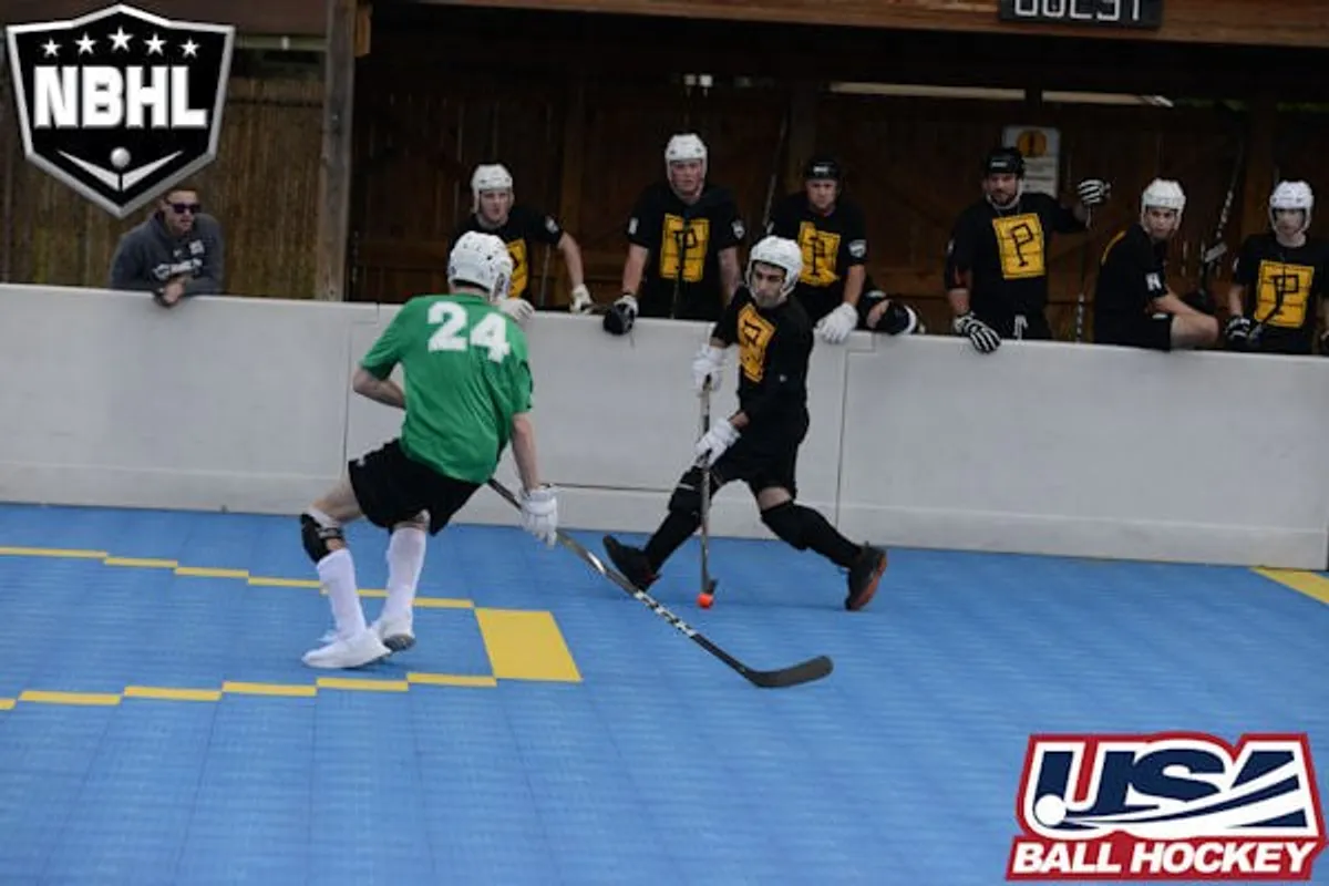 Mark in the black and gold Pittsburgh Pioneers jersey, carrying the ball along the boards in a 2021 NBHL game.