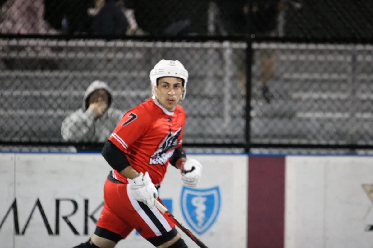 Mark in the Mon Valley Warbirds jersey, number 7, skating up the rink during a night game.